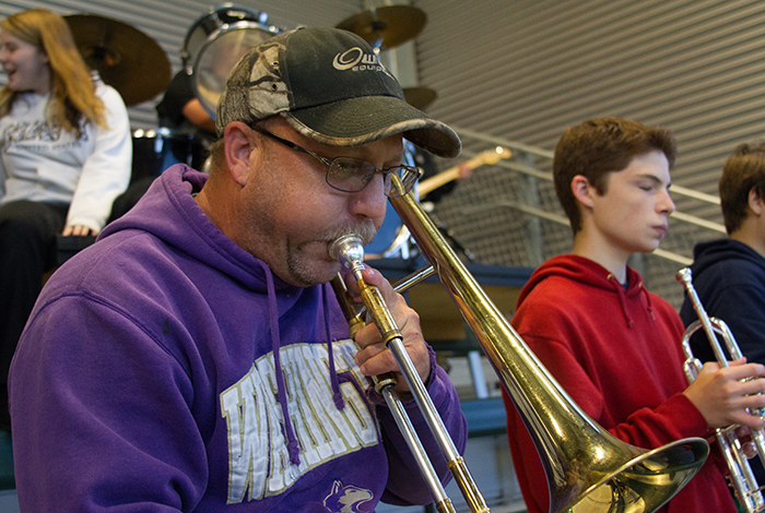 Jim Bair volunteered to play trombone at Woodland's football games after his daughter convinced him to participate last year.