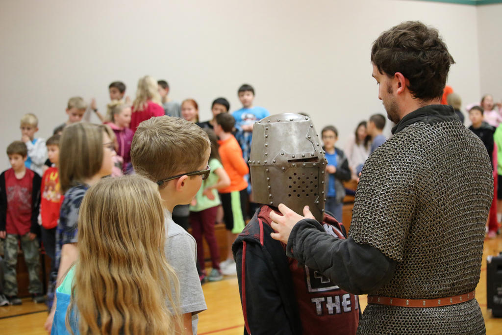 Students examine helmet