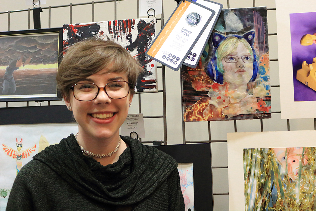 Mountain View High School student Lany Wilks next to her piece "Pacifying Bedlam", which won an ESD 112 Award and scholarship.