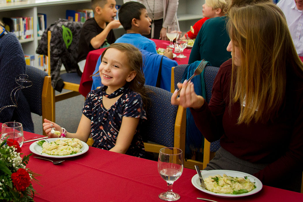 Students learn proper table etiquette and try new foods during the Fine Dining Event at Woodland Intermediate School