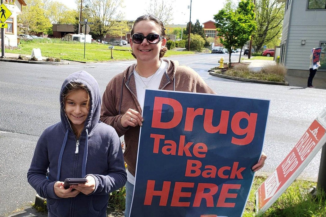 Volunteers hold a Drug Take Back sign in Washougal