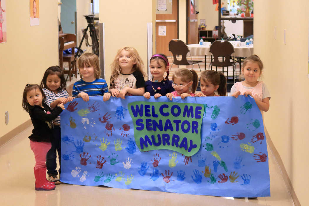 Welcome, Senator Murray banner held by preschoolers