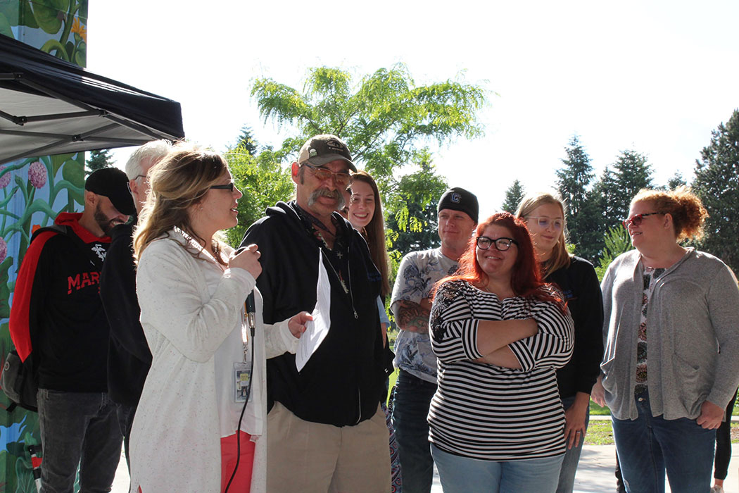 Alaina Green, coordinator of West Van for Youth Coalition, recognizes Clark College A.C.E.s club (Addiction Counseling Education students) for many years of partnership and service