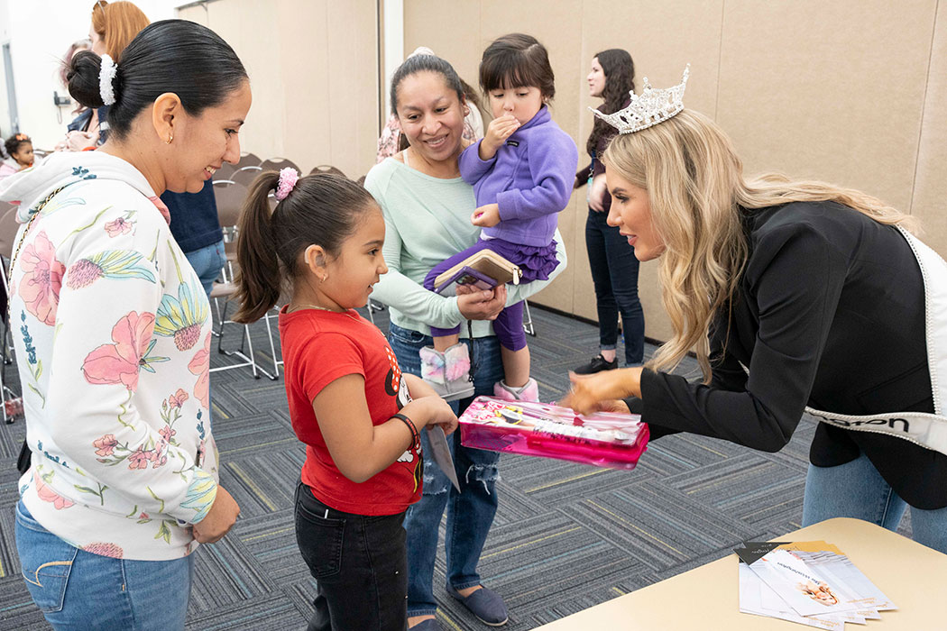 A girl and her family receive a Barbie doll from Miss Washington