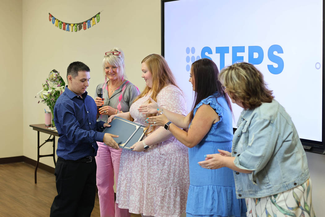 STEPS graduate Diego receiving diploma