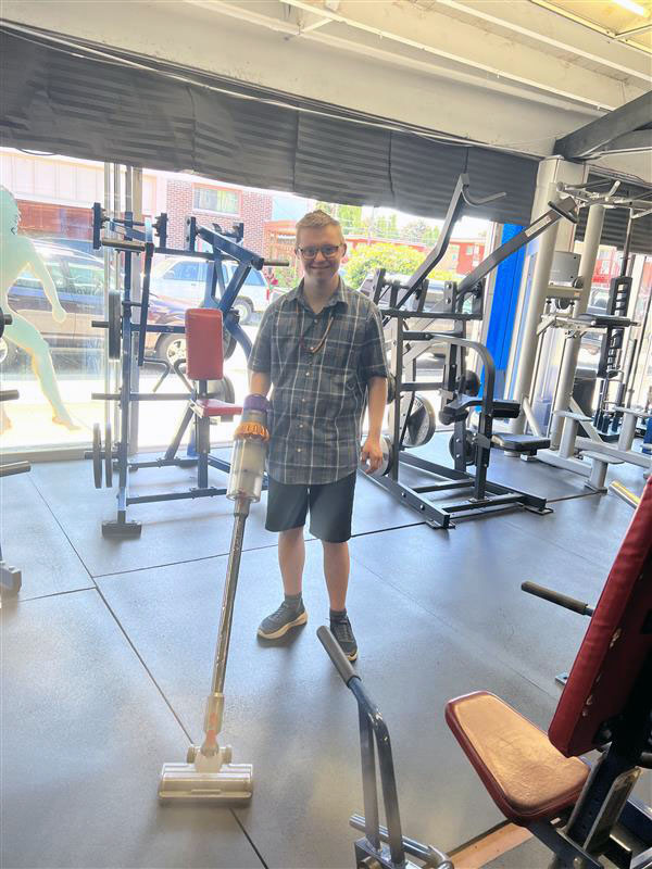 STEPS student vacuuming at the Forever Fit Gym